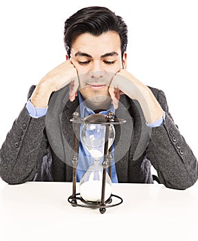 Businessman looking at the hour glass