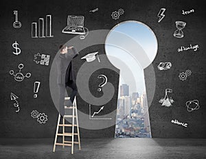 Businessman looking on keyhole