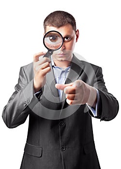 Businessman looking through a magnifying glass