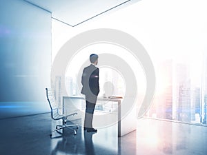 Businessman looking megalopolis through window