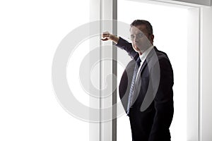 Businessman Looking Out a Big Window