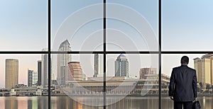 Businessman Looking Out From An Office Window