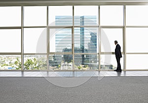 Businessman Looking Out Of Office Window