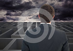 Businessman looking over a maze