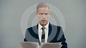 Businessman looking at papers isolated on
