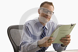 Businessman Looking at Paperwork - Isolated