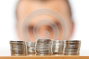 Businessman looking at piles of pennies