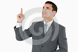 Businessman looking and pointing upwards