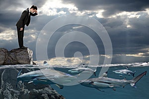 Businessman Looking at Sharks Swimming