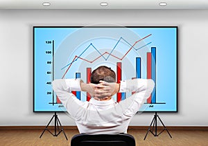 Businessman looking to chart