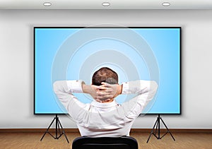 Businessman looking to plasma panel