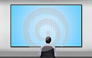 Businessman looking to plasma panel