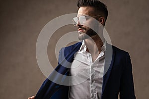 Businessman looking to the side, pulling his jacket