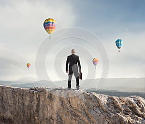 Businessman looks far to the future of the business