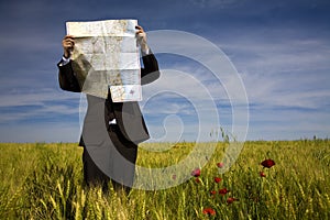 Businessman lost in field photo