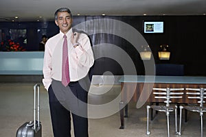 Businessman With Luggage In Hotel Lobby