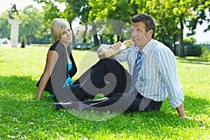 Businessman on lunch break sitting in grass