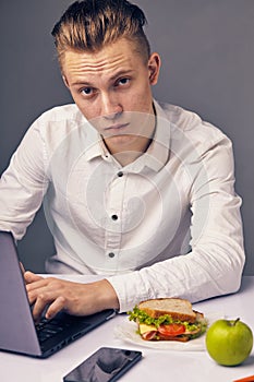 Man while lunch at the office looking at camera