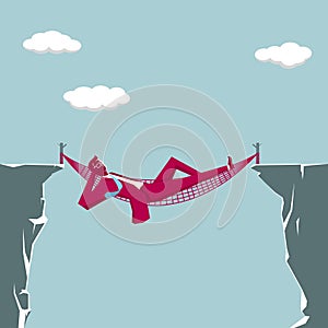 Businessman lying in a hammock on the edge of a cliff.