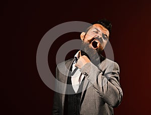 Businessman with mad face on dark red background