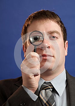 Businessman With Magniying Glass