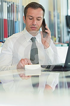 Businessman making calls from office