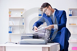 The businessman making copies in copying machine