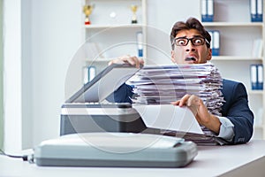 The businessman making copies in copying machine