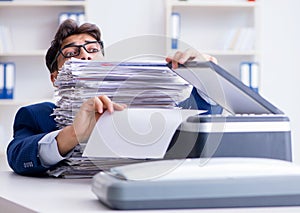 The businessman making copies in copying machine