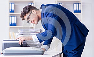 The businessman making copies in copying machine