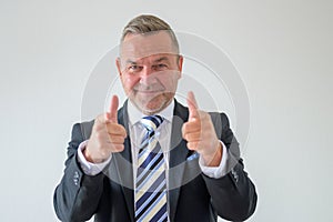 Businessman making a finger gun gesture with both hands