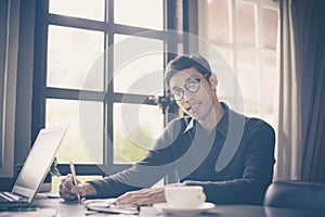 Businessman making notes while working at office