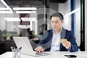 Businessman making online payment in modern office