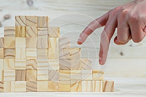 Businessman making a pyramid with empty wooden cubes