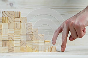 businessman making a pyramid with empty wooden cubes