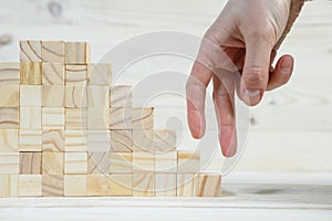 businessman making a pyramid with empty wooden cubes