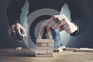 Businessman making a pyramid with empty wooden cubes