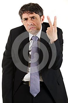 Businessman making a rude v-sign photo