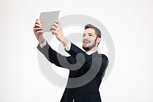 Businessman making selfie photo on tablet computer