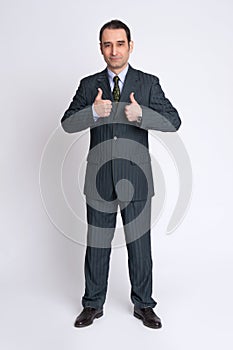 Businessman making the thumbs up gesture