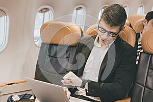 Businessman male looking at wrist watch for worry meeting late from flight delay