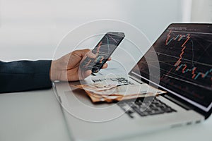 Businessman man counting euro money working on computer and smartphone at office desk, inflation concept.