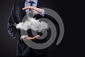 Businessman man hand holding cloud.Cloud computing concept, close up of young business man with cloud over his hand.The concept of