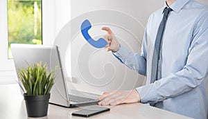 Businessman man hold phone icon.Call Now Business Communication Support Center Customer Service Technology Concept