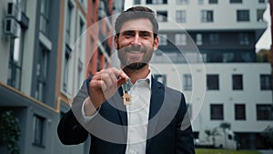 Businessman man real estate manager tenant broker homeowner salesman buyer male hold keys from new house building rental