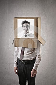 Businessman with a man's picture on a box on his head