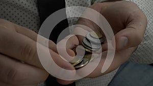 Businessman or manager counting coins in hands