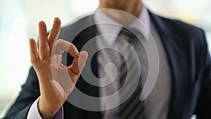 Businessman manager showing ok gesture in office closeup