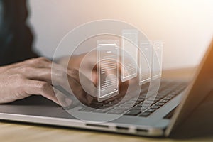 Businessman managing electronic documents on the laptop.