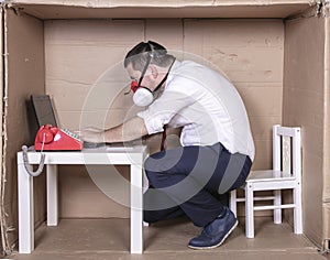 Businessman with mask on his face working hard on his laptop